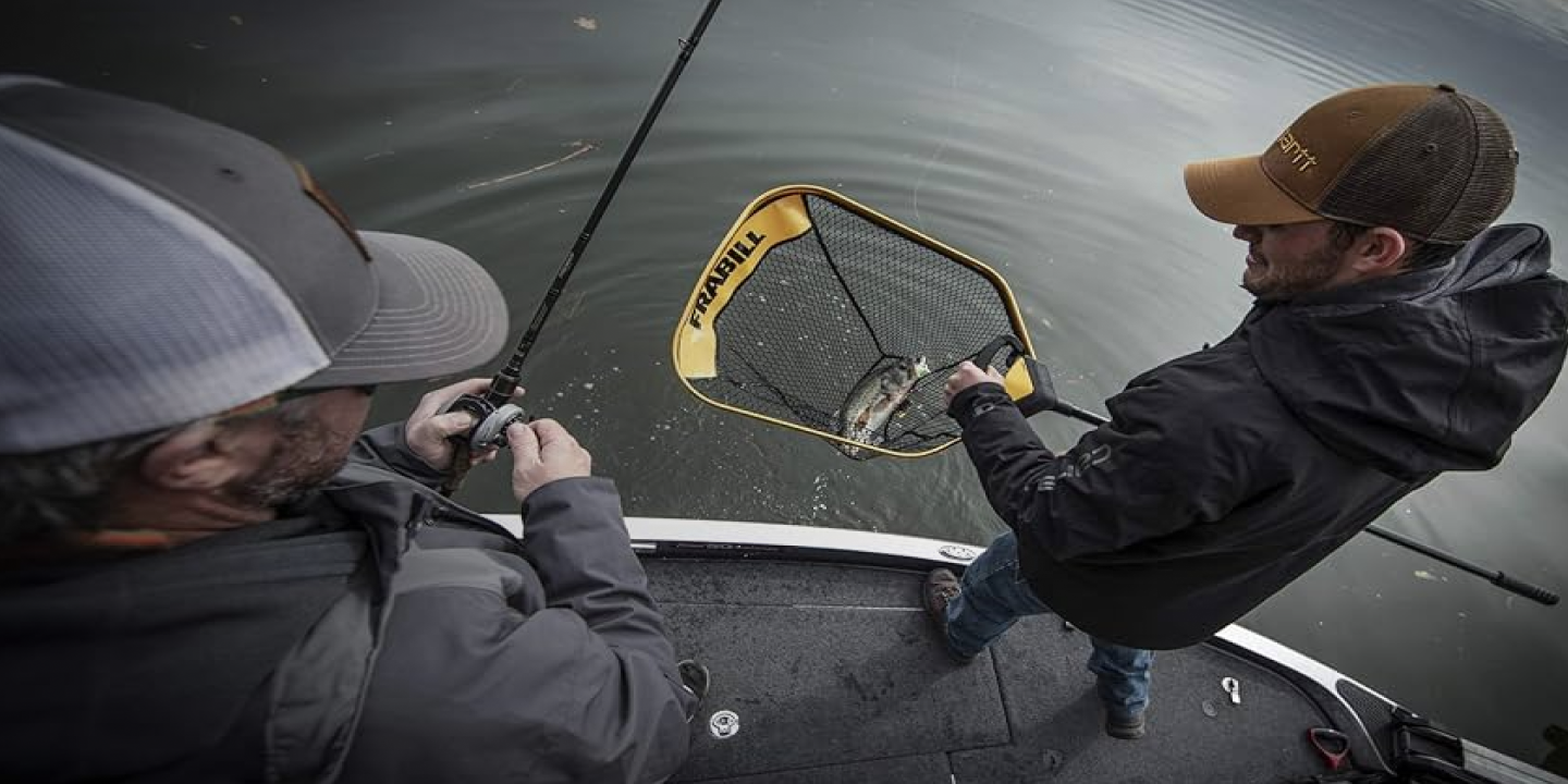 2 guys fishing and caught a fish in a net
