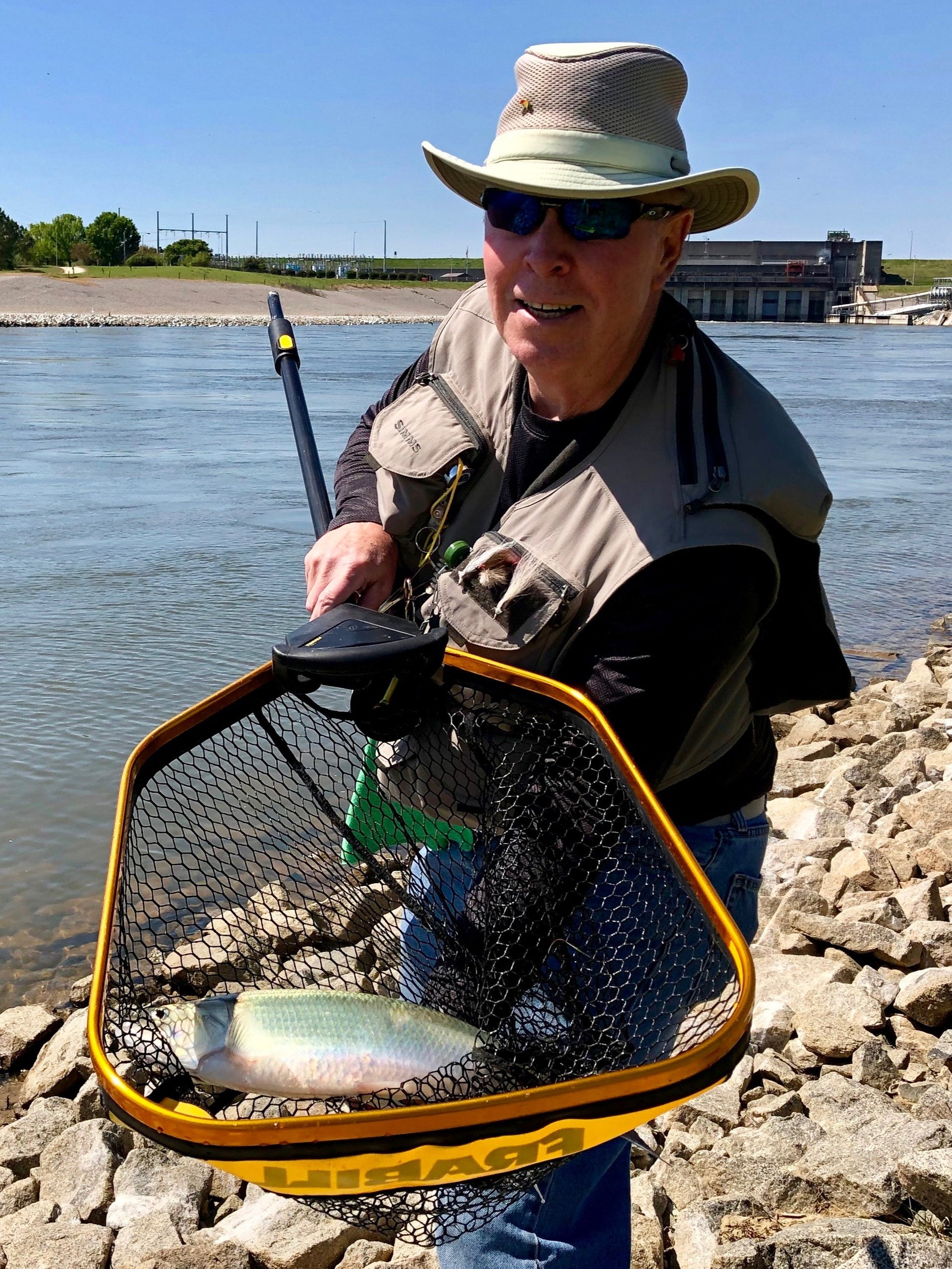 Guy holding a fish caught in a net